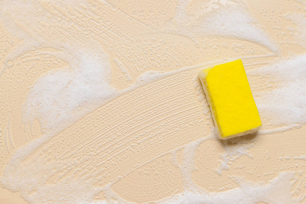 Cleaning sponge with foam on color background - Photo, Image