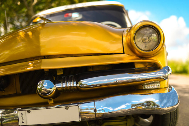 classic golden yellow old car, auto in Cuba, space for text on registration - Photo, Image