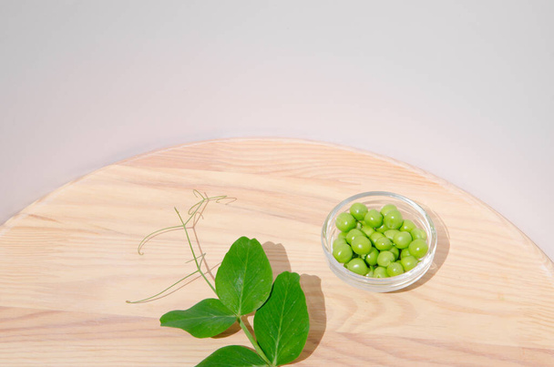 Green pea in glass bowl of top view on rustic wooden background with copy space, natural wooden table. Flat lay. - Foto, imagen