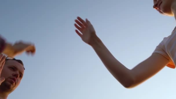 Ihmiset nostavat kätensä taivasta kohti, taputtavat toistensa käsiä - Materiaali, video