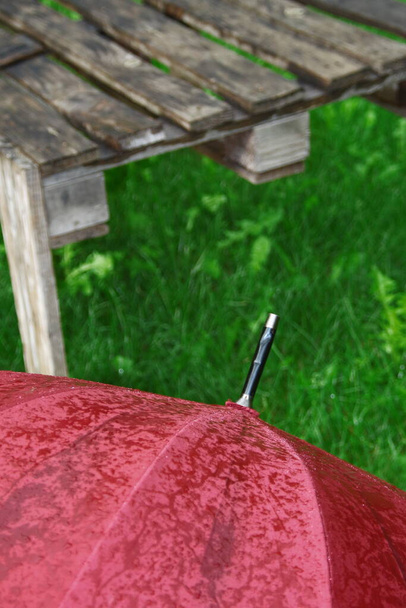 Big red umbrella with drops of water after the rain - Photo, Image