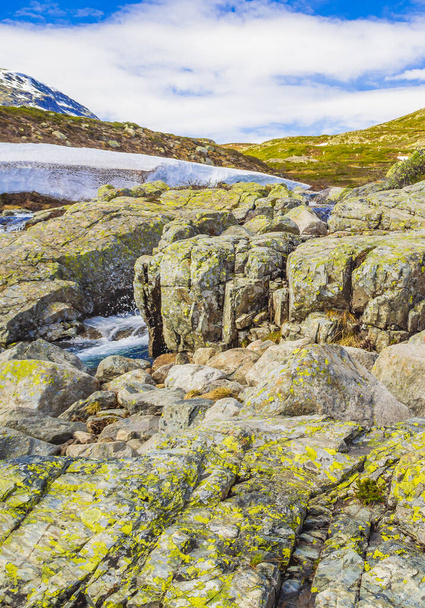 Beautiful Storebottane river by the vavatn lake with snow in the summer landscape in Hemsedal Norway. - 写真・画像