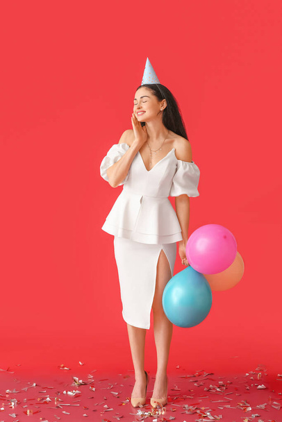 Beautiful woman with balloons on color background - Photo, image