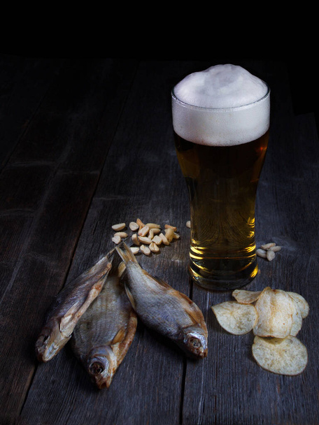 Beer and fish, snacks for beer on a wooden table - Photo, Image