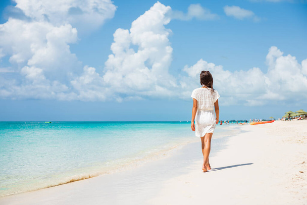 Caribbean beach luxury vacation summer holiday woman walking on perfect white sand tourist destination. - Фото, зображення