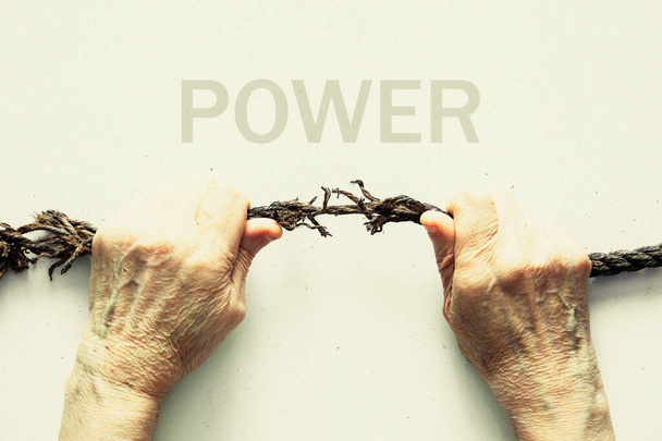 hands pull an old rope on a white background, human strength - Photo, Image