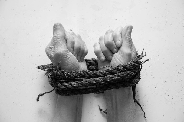 tied hands with rope old woman on white background - Photo, Image