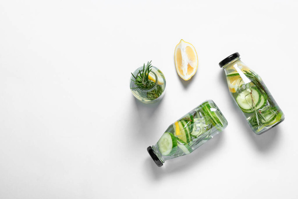 Bottles with cucumber lemonade on white  background - Fotoğraf, Görsel