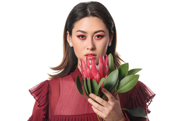 Beautiful young woman with protea flower on white background - Photo, image