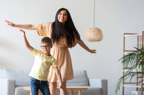 Young woman and her little son dancing at home - Photo, Image