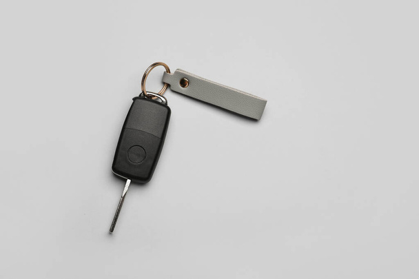 Car key with leather keychain on grey background - Photo, Image