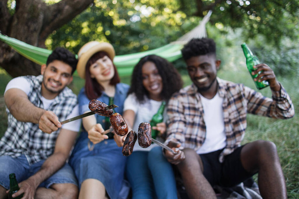 Multicultural people having picnic with grilled sausages - Φωτογραφία, εικόνα