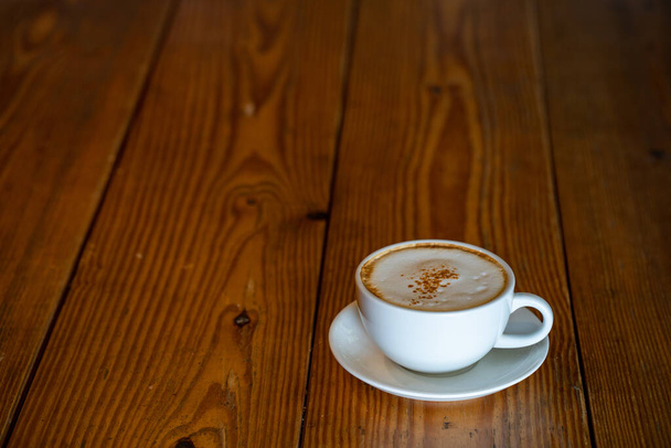 A closeup shot of a morning coffee on a wooden table - Фото, изображение