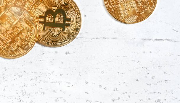 Top down view, golden commemorative btc - bitcoin cryptocurrency - coins on white stone board, closeup detail, space for text down right corner - Zdjęcie, obraz