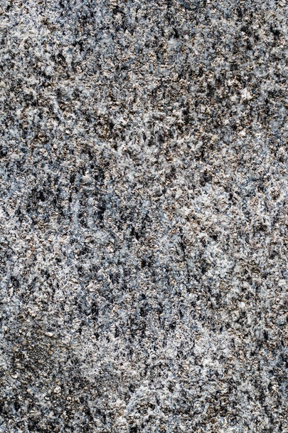 A vertical closeup shot of black and white grainy marble - Foto, afbeelding