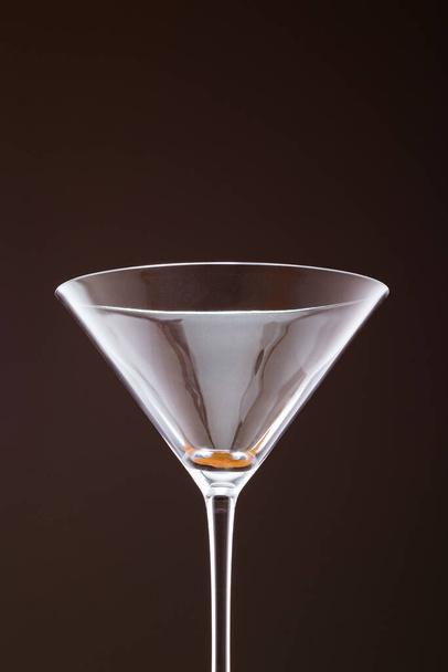 An empty champagne glass bottle with champagne isolated on a dark background - Foto, afbeelding