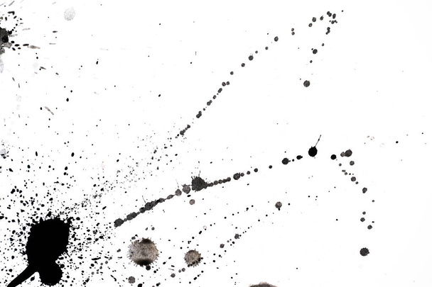 A messy black ink scattered on a white surface with copy space - Photo, image