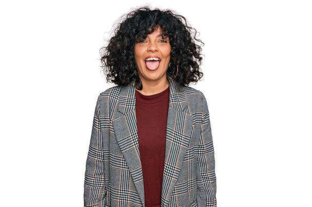 Young hispanic woman wearing business clothes sticking tongue out happy with funny expression. emotion concept.  - Foto, imagen