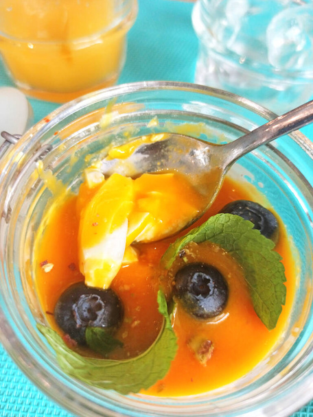 pannacotta dessert with mango and blueberry in jar. served at blue napkin - 写真・画像
