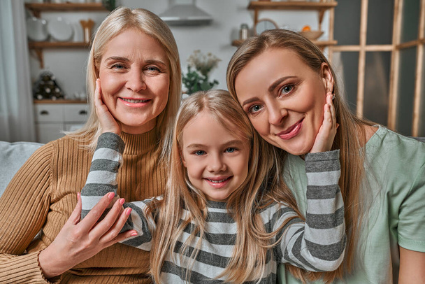 Family portrait of mother, daughter and grandmother. Generation of women. The concept of Women's Day, Mother's Day, Spring Day, psychology of child rearing, genetics, care and motherhood. - Photo, image