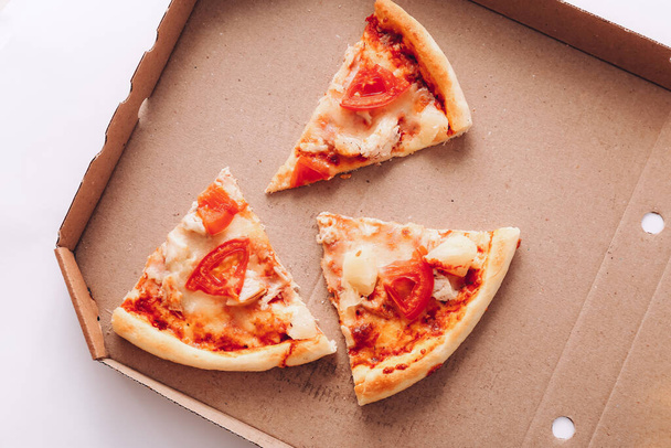 Tasty pizza pieces in delivery box, close up - Zdjęcie, obraz