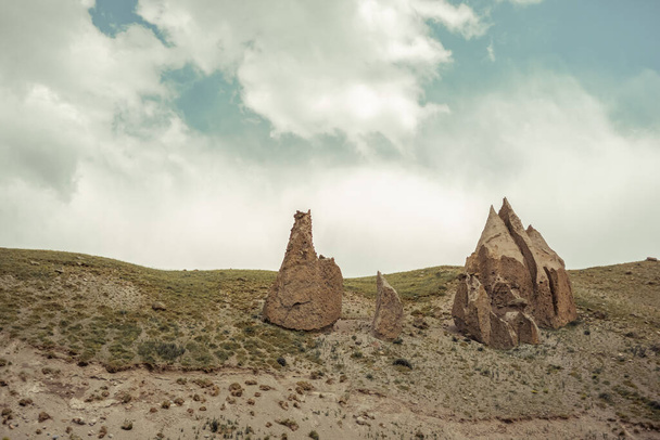 An unusual, as if alien landscape: sharp huge stones against the sky - Foto, Imagen