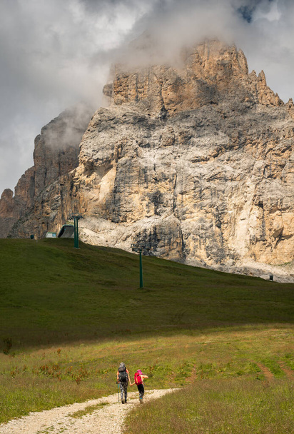 Hiking in the Dolomites mountains on a sunny and cloudy day. - Photo, Image