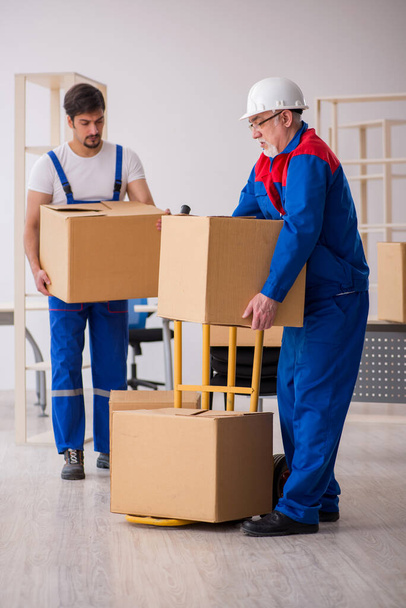 Two male professional movers doing home relocation - Photo, Image