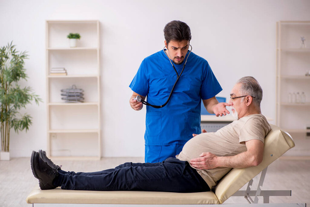 Old male patient visting young male doctor - Photo, Image