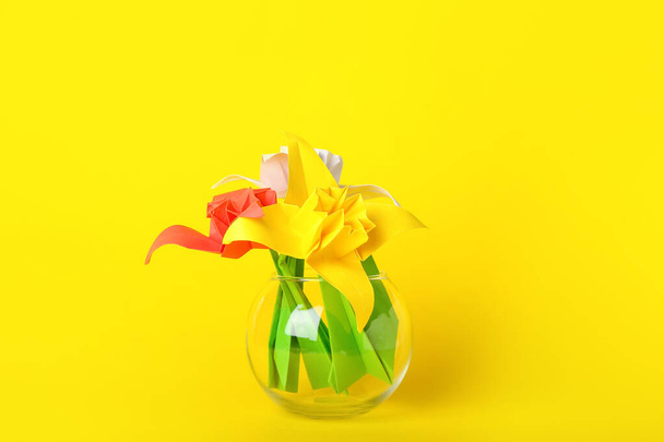 Vase with origami daffodils on color background - Фото, зображення