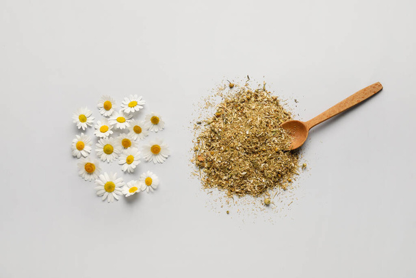 Dried and fresh chamomile tea on grey background - Photo, Image