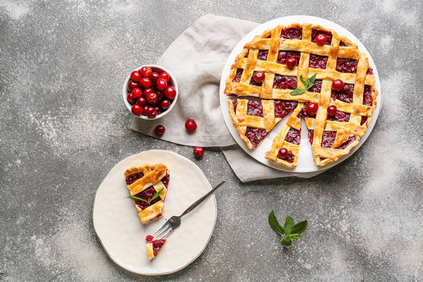 Composition with tasty cherry pie on grunge background - Photo, Image