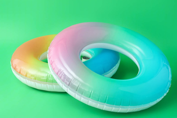 Inflatable rings on color background - Fotoğraf, Görsel