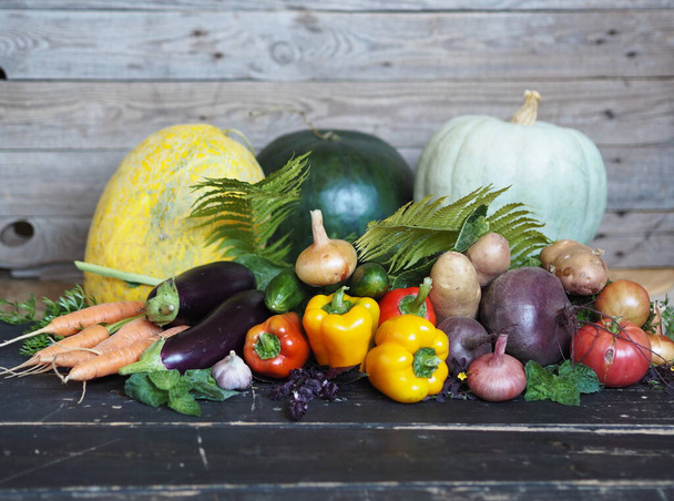 Autumn harvest. Free copy space. Various natural vegetables and fruits, grown in the country, on a dark wooden background. - Фото, изображение