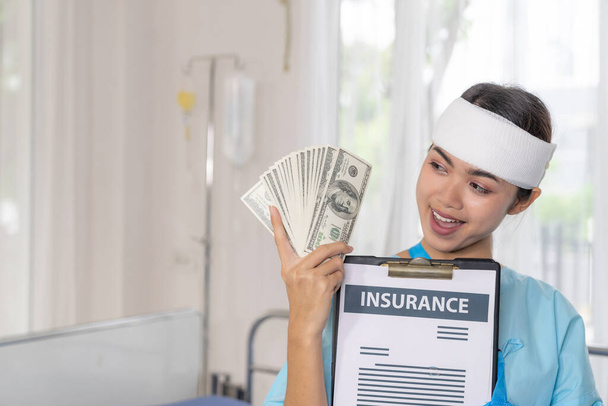 accident patients injury  woman on Patient's bed in hospital  holding us dollar bills feel happy from getting insurance money From insurance companies- medical concept - Photo, Image