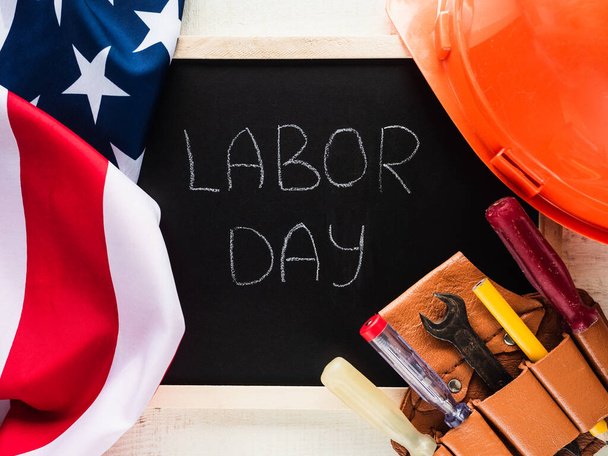 LABOR DAY. Hand tools lying on the table. View from above, close-up. Preparing for the celebration. Congratulations to loved ones, family, relatives, friends and colleagues. National holiday concept - Foto, Imagen