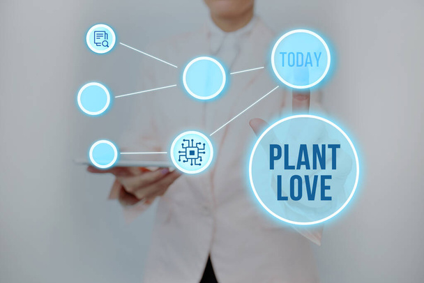 植物の愛を示すインスピレーション。ビジネスは感情的な愛のシンボルを紹介します,ケアとサポートは、仮想ボタンを押して他の女性がタブレットを保持することを示し未来的な技術を示す. - 写真・画像