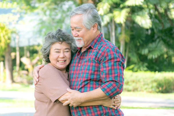 Glückliche Liebe Älteres Paar lächelt Gesicht, älteres Paar alter Mann und ältere Frau umarmen sich entspannt im Wald - Foto, Bild