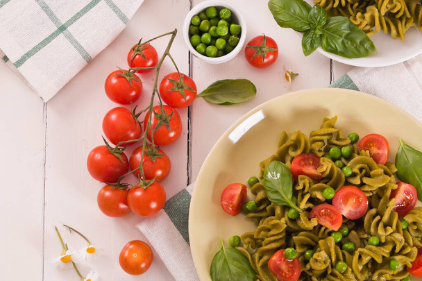 Fusilli pasta with cherry tomatoes and peas. - Zdjęcie, obraz