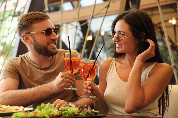 Lovely couple with Aperol spritz cocktails resting together at restaurant - Photo, image