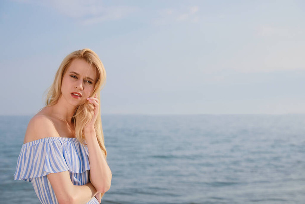 Beautiful young woman near sea on sunny day, space for text - Foto, Imagen