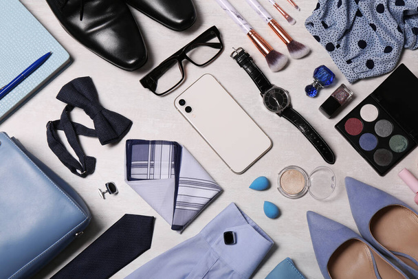 Flat lay composition with fashionable woman's and man's accessories on light background - Fotoğraf, Görsel
