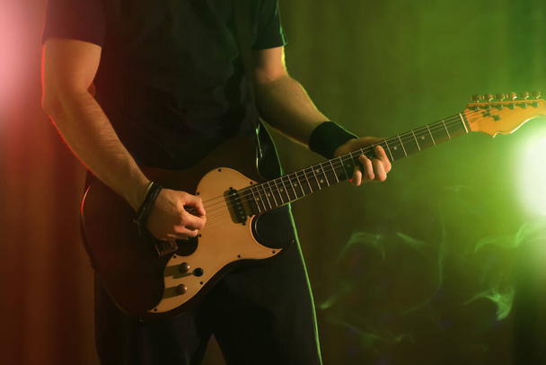 Man playing electric guitar on stage, closeup. Rock music - Fotografie, Obrázek