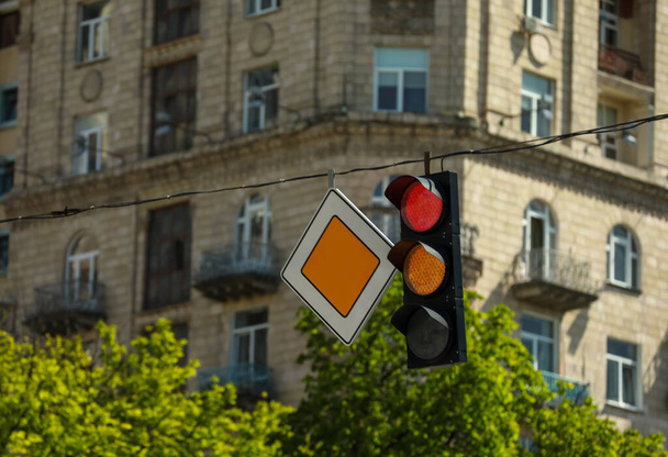 View of traffic light and road sign in city, space for text - Фото, зображення