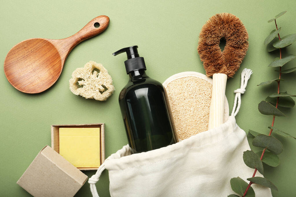 Flat lay composition with eco friendly products on green background - 写真・画像
