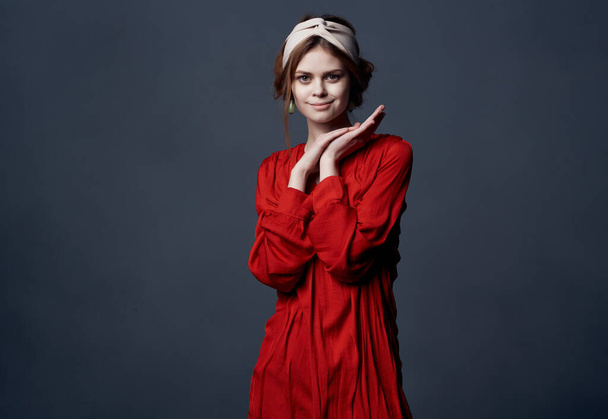 woman in red dress posing in studio - Zdjęcie, obraz