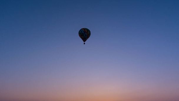 color hot air balloon in sky cloud and sunrise background at the morning time  - Fotó, kép