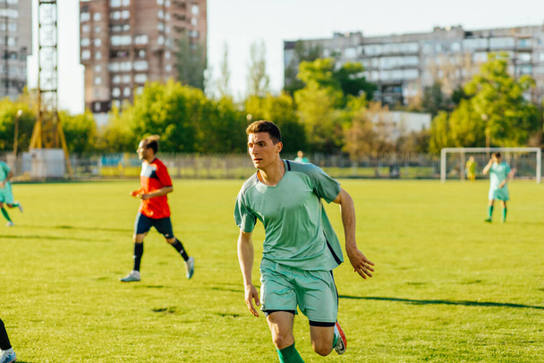 Sports soccer players in training, soccer players kick soccer balls in training, on training soccer field - Fotó, kép