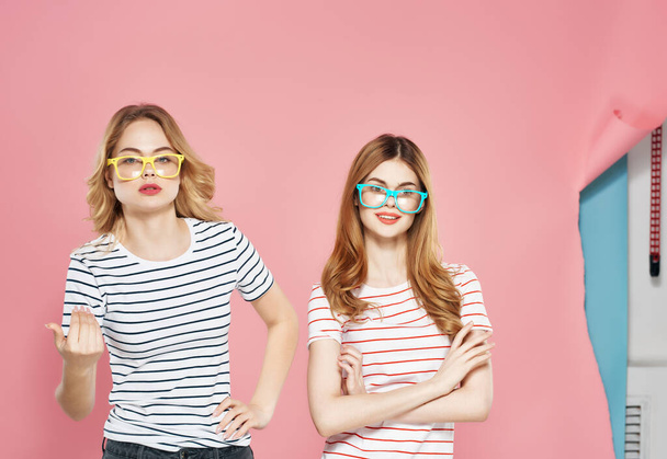 two girlfriends stand side by side charm fun lifestyle isolated background - 写真・画像