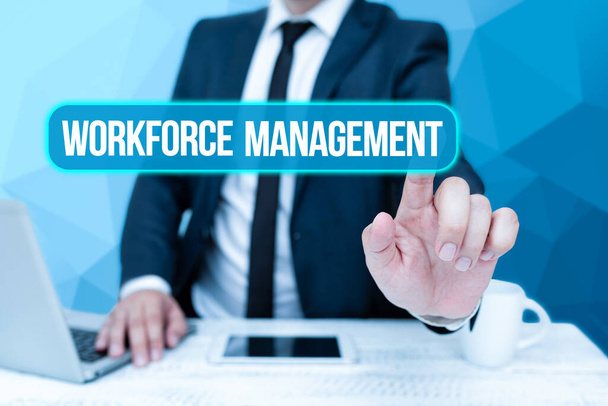 Handwriting text Workforce Management. Business showcase use to optimize the productivity of its employees Bussiness Man Sitting Desk Laptop And Phone Pointing Futuristic Technology. - Photo, Image
